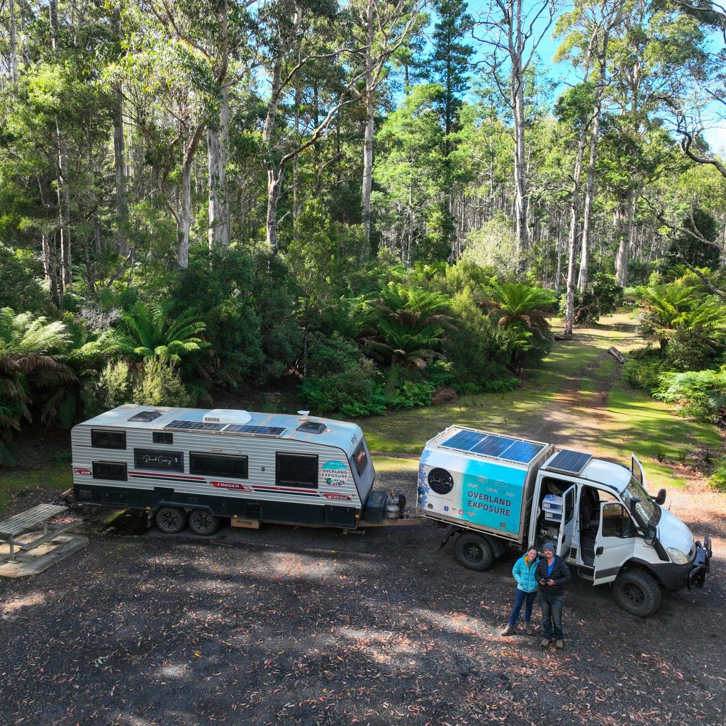 Truck and caravan camping in a forest campground while the family in travelling Tasmania, Australia