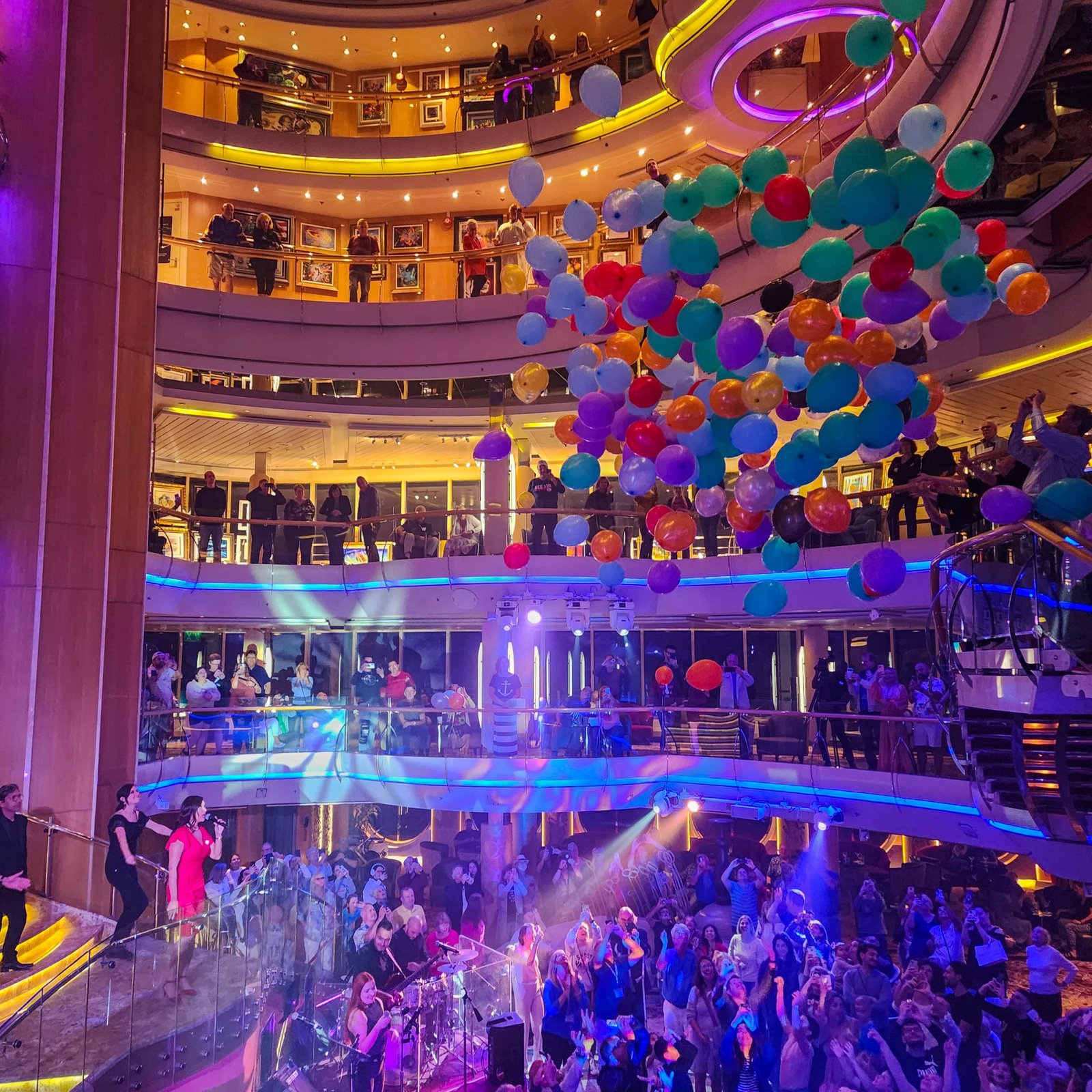 Balloons dropping from above onto the cruise ship passengers