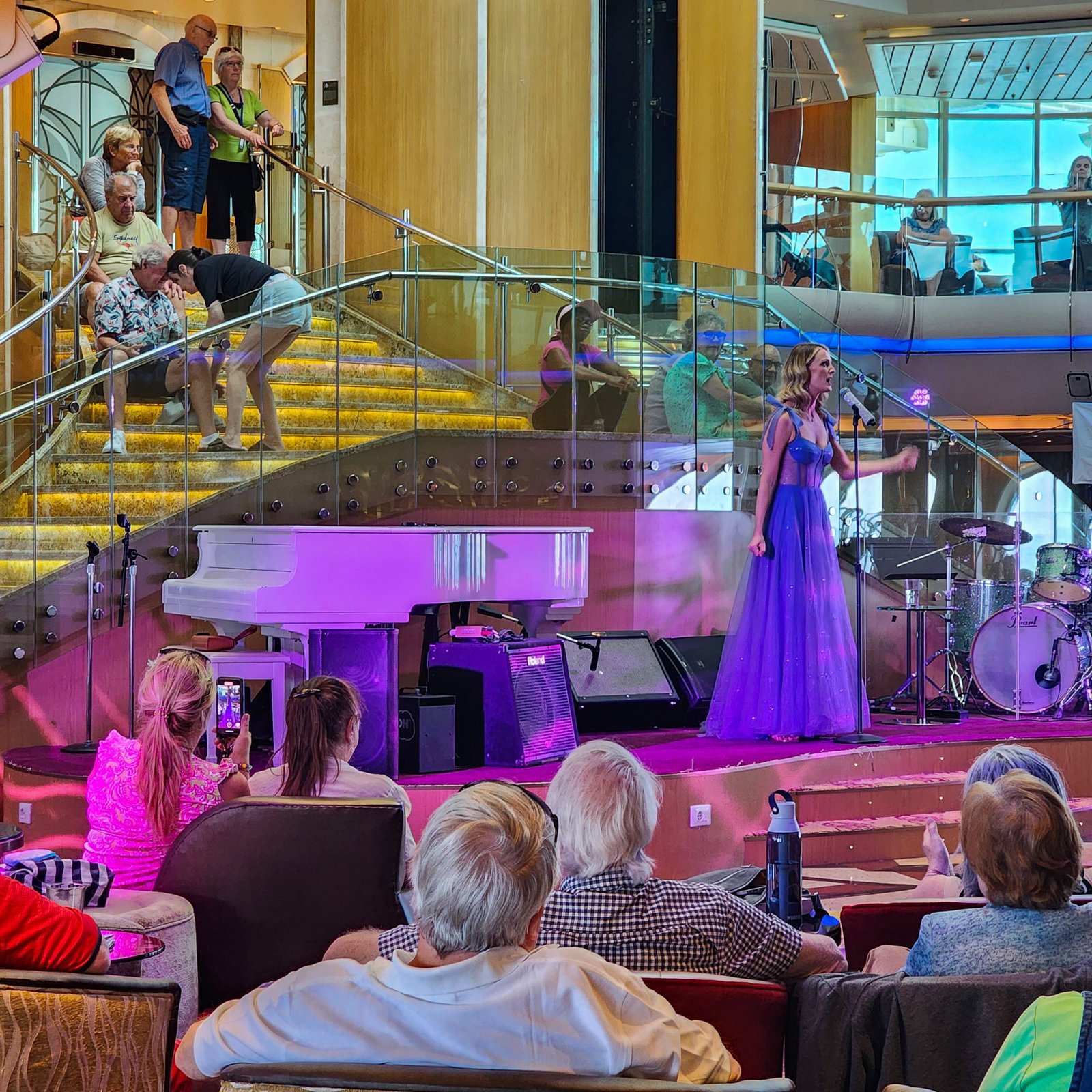 Singer in the auditorium of the cruise ship with an audience watching