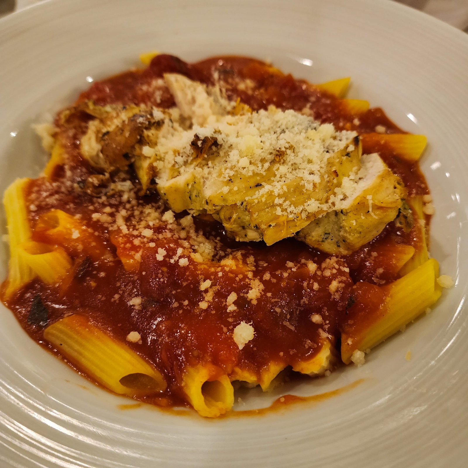 Gluten free pasta with a tomato sauce and parmesan cheese.