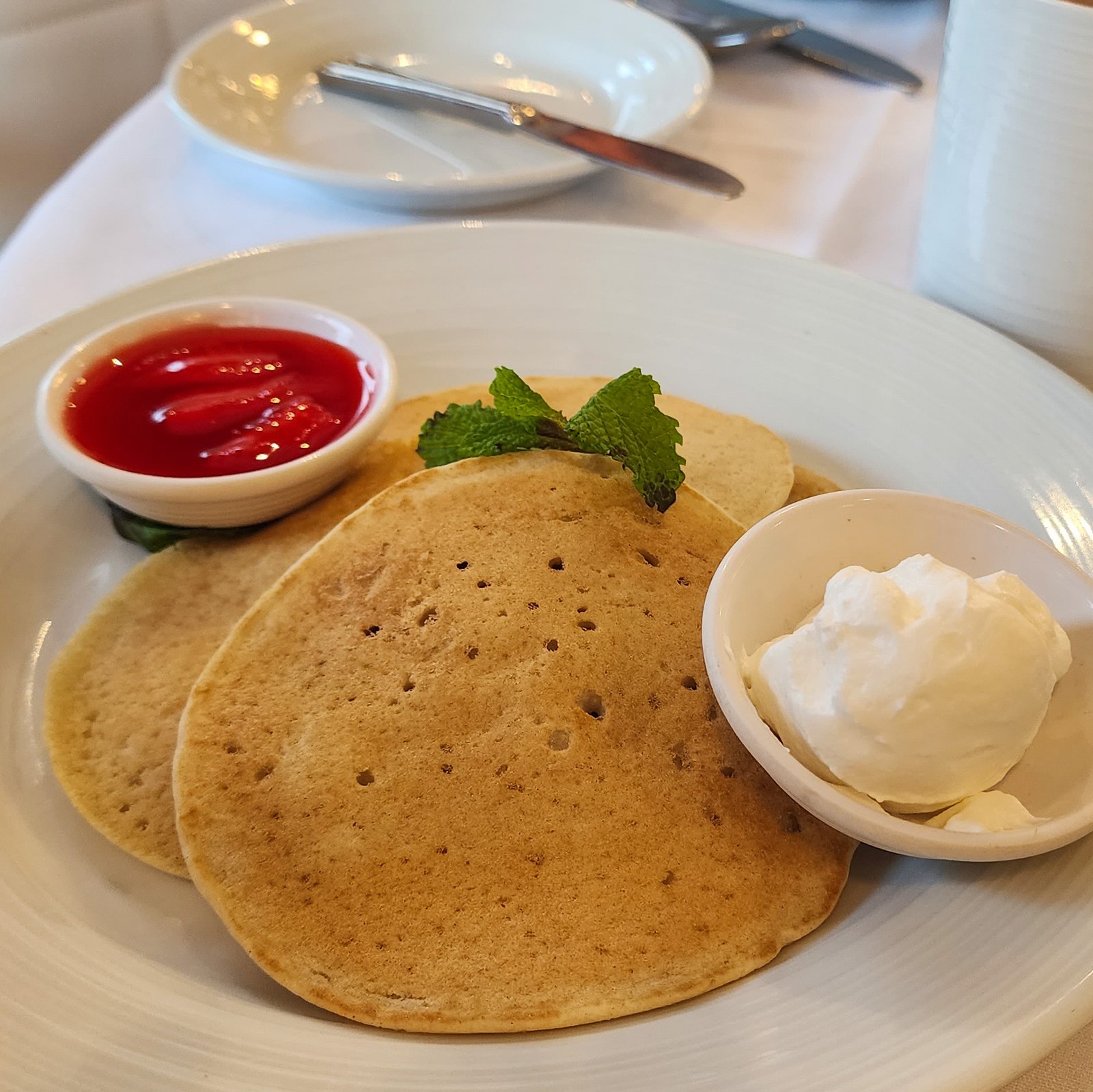 Gluten free pancakes with ice-cream and strawberry compote