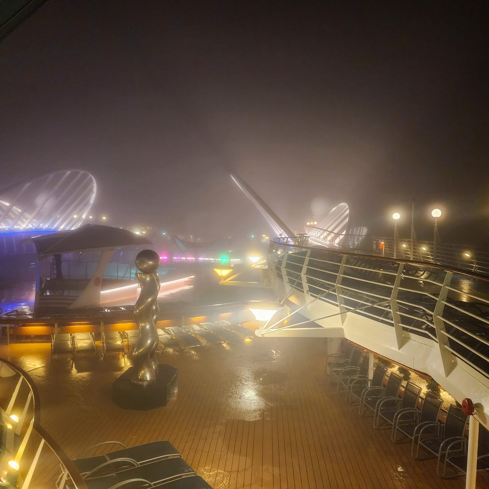 Fog on the top deck of a cruise ship at night